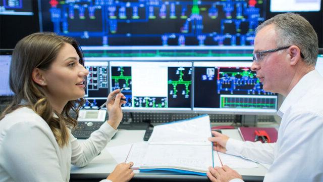 Employees at Kosovo’s transmission system operator discuss processes for managing electricity flows